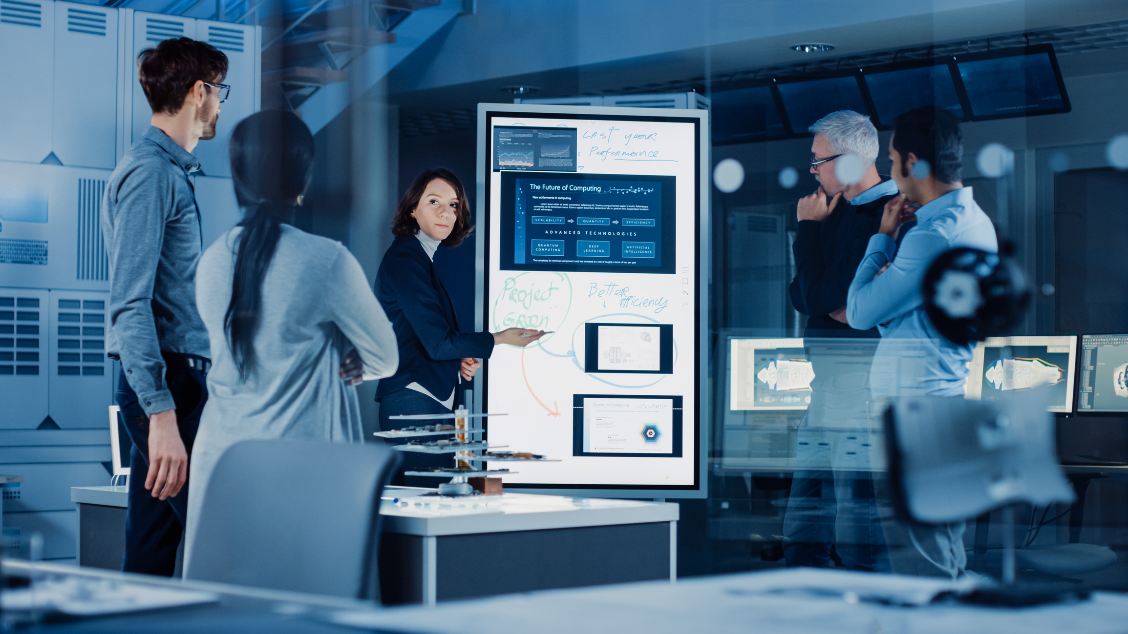 Professionals analyzing diagrams in conference room
