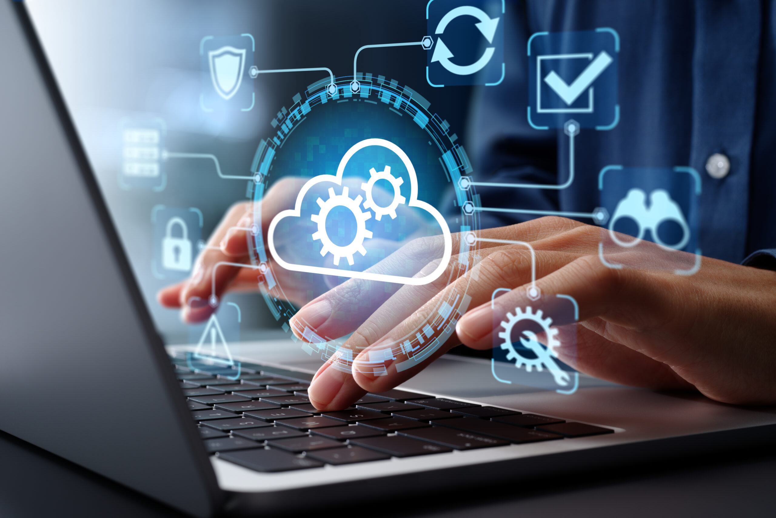 Hands typing with cloud technology icons