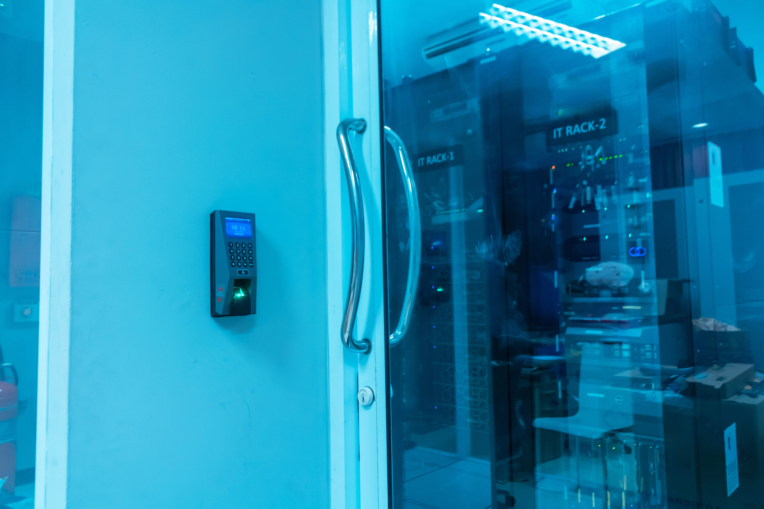 High-tech security access system on a glass door in a data center, showcasing advanced technology for secure entry to IT equipment and server management.