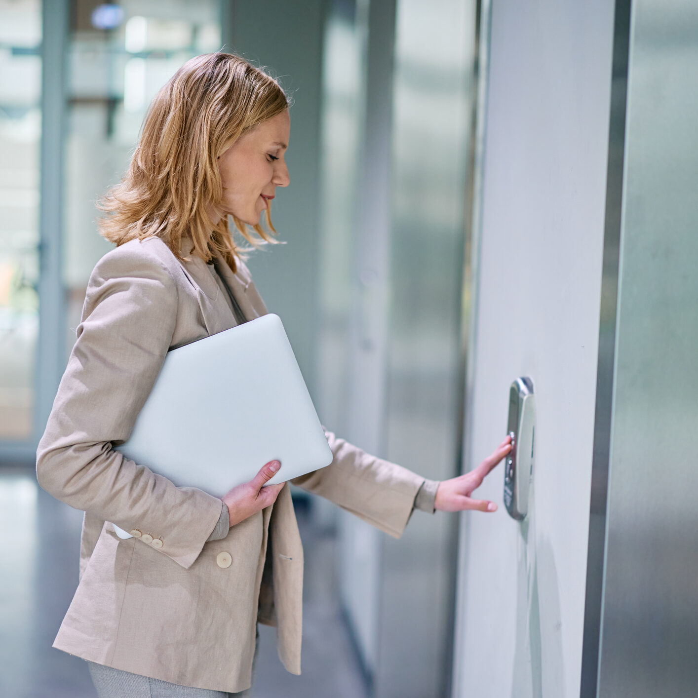 Woman pressing elevator button